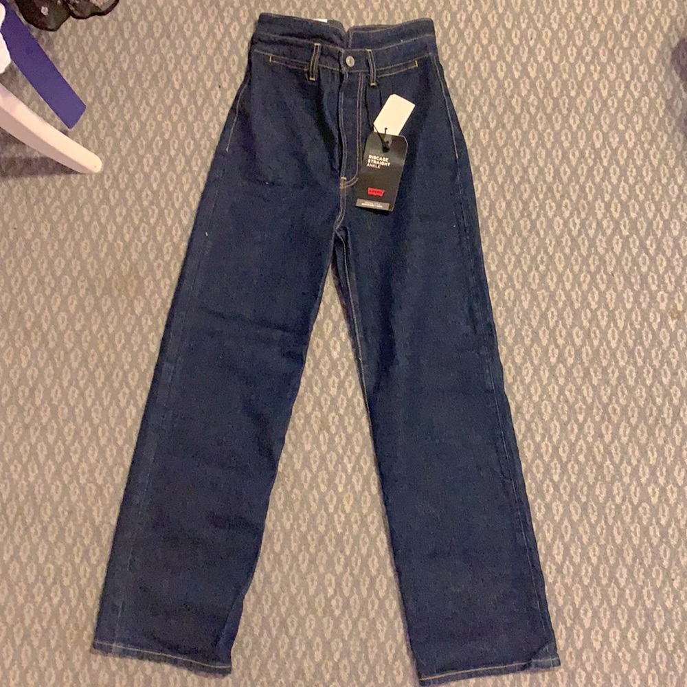 New, never been worn Levi jeans. High waisted rib cage, dark blue, straight leg.
